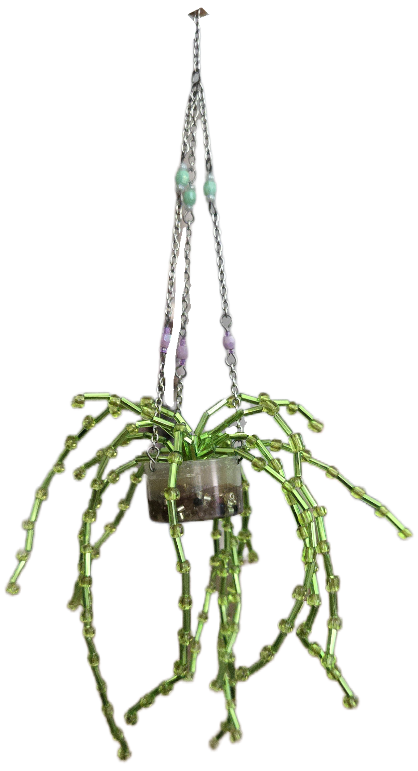 A small string of pearls plant made out of translucent seed beads. The plant sits in a clear pot with translucent resin as the dirt and three chains attached so it can be hung up.